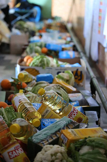 A box of food and produce being prepared for distribution to refugees; the Genesis Prize Foundation provided grants to organizations supporting refugees in honor of 2017 Genesis Prize Laureate Anish Kapoor