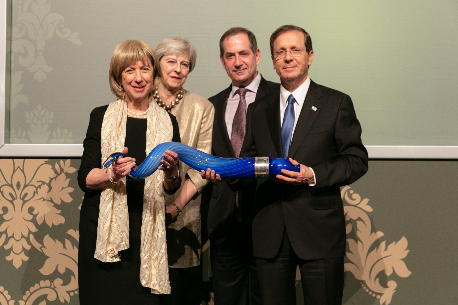 From L to R: Lady Elaine Sacks, former Prime Minister of the United Kingdom Theresa May, Genesis Prize Foundation Founder and Chairman Stan Polovets, President of Israel Isaac Herzog. Credit: Thomas Alexander/Genesis Prize Foundation